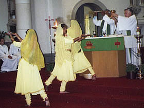 The triple arati done with a plate of flowers, fire and incense sticks