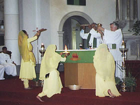 The triple arati done with a plate of flowers, fire and incense sticks
